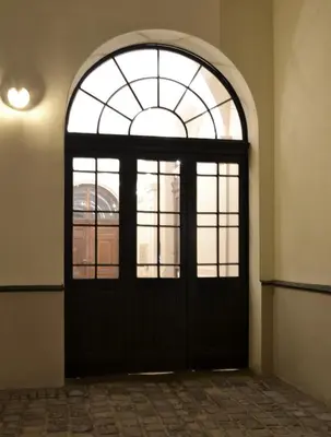 an entrance to a building with a large glass door at 777 Apartaments in Kraków