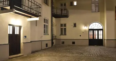 an empty hallway of a building with a door and windows at 777 Apartaments in Kraków