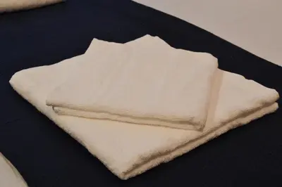 a pile of white towels sitting on a table at 777 Apartaments in Kraków