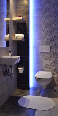 a bathroom with a white toilet and a sink at 777 Apartaments in Kraków