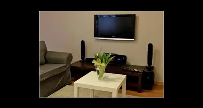 a living room with a couch and a table and a tv at 777 Apartaments in Kraków