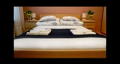 a bedroom with two beds with towels on them at 777 Apartaments in Kraków