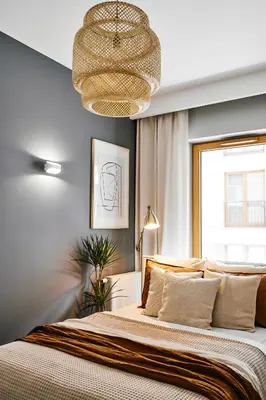 a bedroom with a large bed and a chandelier at Main Station Art Apartment in Kraków