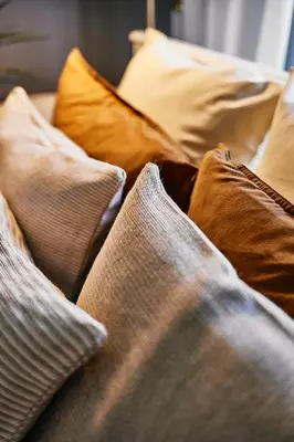 a pile of pillows on a bed at Main Station Art Apartment in Kraków