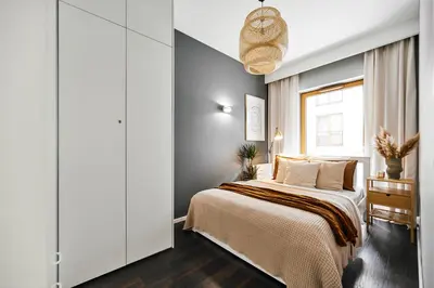 a bedroom with a large bed and a window at Main Station Art Apartment in Kraków