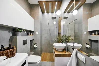a bathroom with two sinks and a toilet at Main Station Art Apartment in Kraków