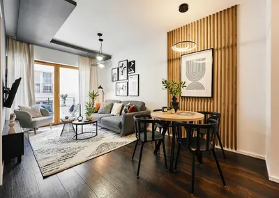 a living room with a table and a couch at Main Station Art Apartment in Kraków