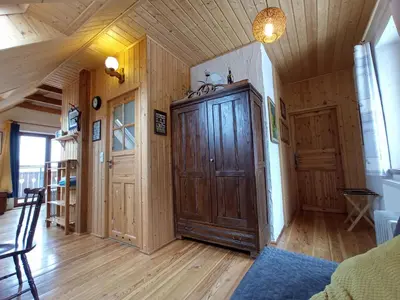 a room with a large wooden cabinet in a house at Agroturystyka Millerówka in Kamionka Mała