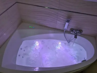 a white bath tub with a water faucet at MARMI Noclegi in Golczowice