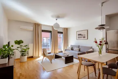 a living room with a couch and a table at Wygodny Apartament Przy Dworcu in Kraków