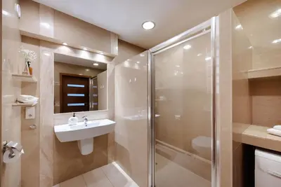 a bathroom with a shower and a sink at Wygodny Apartament Przy Dworcu in Kraków