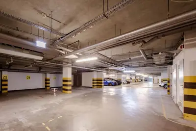 an empty parking garage with cars parked in it at Wygodny Apartament Przy Dworcu in Kraków