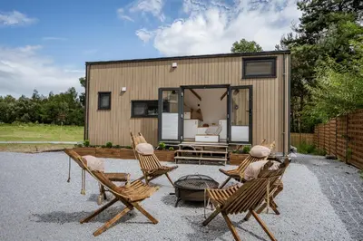 a couple of chairs and a tiny house at Staymoovers - Tinyhouse Zator in Zator