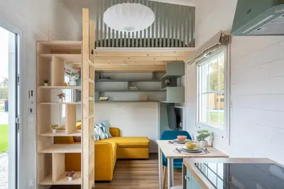 a tiny house with a loft bed in the living room at Staymoovers - Tinyhouse Zator in Zator