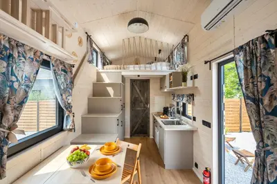 a tiny kitchen and dining room in a tiny house at Staymoovers - Tinyhouse Zator in Zator