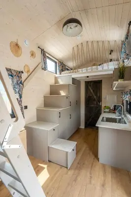 a tiny house with a staircase and a kitchen at Staymoovers - Tinyhouse Zator in Zator