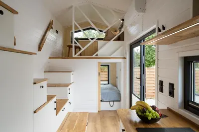 a tiny house with a kitchen and a bedroom at Staymoovers - Tinyhouse Zator in Zator