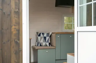a tiny house with a bench and a window at Staymoovers - Tinyhouse Zator in Zator