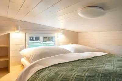 a bedroom with two beds and a window at Staymoovers - Tinyhouse Zator in Zator