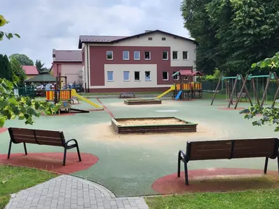 a playground with benches and slides in a park at Scandilook Apartament in Zator