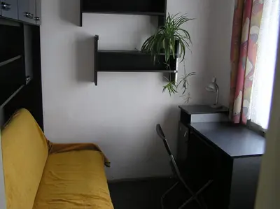 a bedroom with a yellow bed and a desk with a plant at 2d likwi klimatyzacja mieszkanie z kuchnią normalne dwupokojowe in Kraków