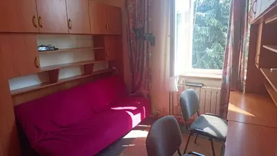 a red couch in a room with a window at 2d likwi klimatyzacja mieszkanie z kuchnią normalne dwupokojowe in Kraków