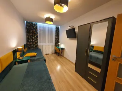 a living room with a couch and a table at Komfortowo i cicho - Apartament in Kraków