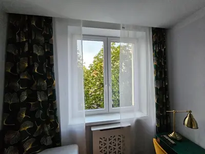 a window in a living room with a curtain at Komfortowo i cicho - Apartament in Kraków