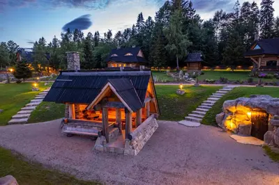 a home with a fire pit in the yard at Loft Na Stodole z jaskinią SPA - Osada Jaworzyny in Zawadka