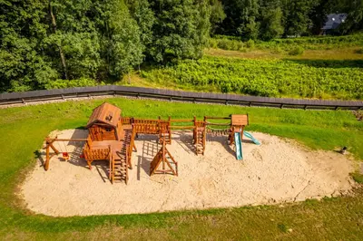 an aerial view of a playground with tables and chairs at Loft Na Stodole z jaskinią SPA - Osada Jaworzyny in Zawadka