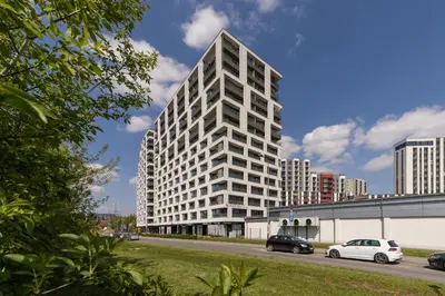 a tall white building with cars parked in front of it at City Centre & Modern Quiet Apartment with Parking by Renters Prestige in Kraków