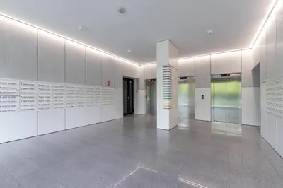 a hallway with white walls and a white floor at City Centre & Modern Quiet Apartment with Parking by Renters Prestige in Kraków