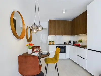 a kitchen with a small table and yellow chairs at City Centre & Modern Quiet Apartment with Parking by Renters Prestige in Kraków