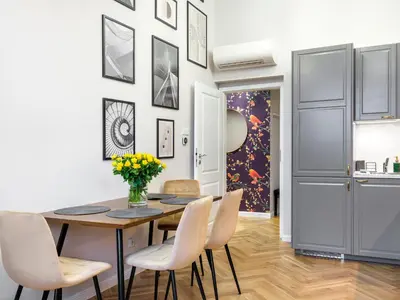 a dining room with a table and chairs at Tyzenhauz Apartments Rakowicka Street in Kraków