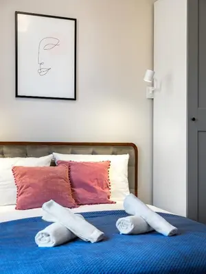 a bed with two pairs of socks on it at Tyzenhauz Apartments Rakowicka Street in Kraków