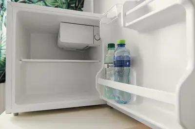 two bottles of water sitting inside of an open refrigerator at Apartment Kazimierz Rzeszowska in Kraków