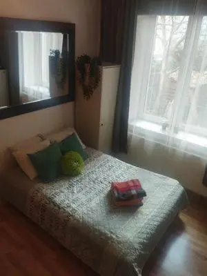 a bedroom with a bed with two pillows and a mirror at Apartment Kazimierz Rzeszowska in Kraków
