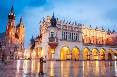 a large building with a clock tower in a city at Apartment Kazimierz Rzeszowska in Kraków
