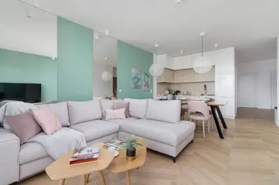 a living room with a white couch and a table at Grzegórzki Park Unique Apartment Cracow by Renters Prestige in Kraków