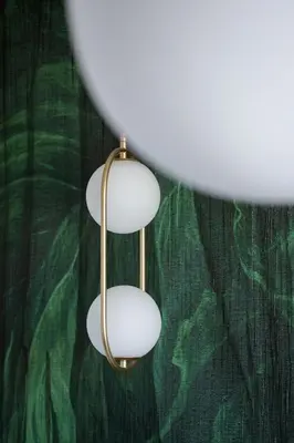 a pair of white lights hanging from a green wall at Grzegórzki Park Unique Apartment Cracow by Renters Prestige in Kraków