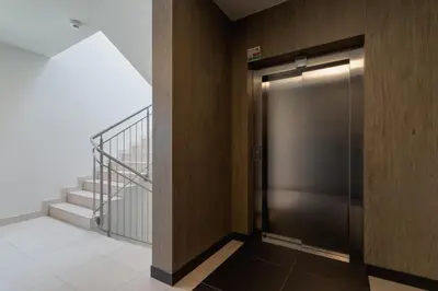 a elevator door in a building with a staircase at Grzegórzki Park Unique Apartment Cracow by Renters Prestige in Kraków