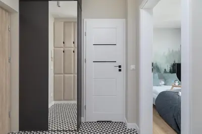 a mirror in a room with a bed and a bedroom at Modern Apartment Grzegórzeckie Roundabout Cracow by Noclegi Renters in Kraków