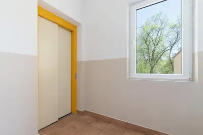 an empty room with a door and a window at Modern Apartment Grzegórzeckie Roundabout Cracow by Noclegi Renters in Kraków