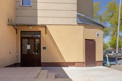 a building with a brown door and a building at Modern Apartment Grzegórzeckie Roundabout Cracow by Noclegi Renters in Kraków