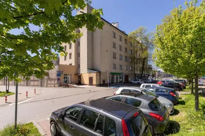 a row of cars parked in front of a building at Modern Apartment Grzegórzeckie Roundabout Cracow by Noclegi Renters in Kraków