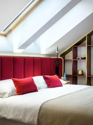 a bedroom with a large bed with red headboard at Golden Queen Deluxe Jacuzzi Apartments - Old Town in Kraków