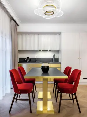 a dining room with a table and red chairs at Golden Queen Deluxe Jacuzzi Apartments - Old Town in Kraków
