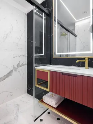 a bathroom with a red vanity and a glass shower at Golden Queen Deluxe Jacuzzi Apartments - Old Town in Kraków