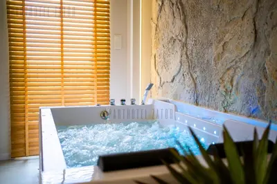 a bathroom with a tub filled with water at Aparthotel ZATOR Cactus 57 jacuzzi in Zator