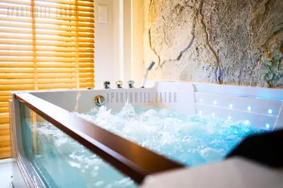 a bathroom with a tub filled with water at Aparthotel ZATOR Cactus 57 jacuzzi in Zator